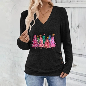 Close-up of V-neckline with colorful Christmas tree prints and side decorative buttons