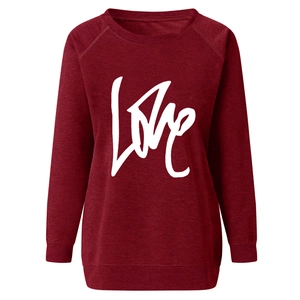 Detail of burgundy sweatshirt featuring a white artistic LOVE graphic print on soft fabric