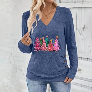 Detail of blue V-neck top showing elegant Christmas tree print and decorative side buttons