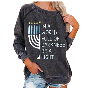Detail of Menorah print and inspirational quote on dark grey washed sweatshirt