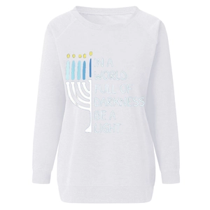 Detail of white sweatshirt featuring Hanukkah Menorah print and Be A Light quote