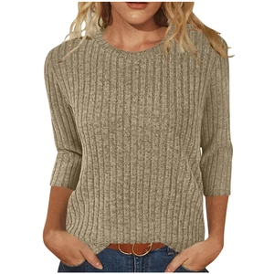 Detail of khaki ribbed knit texture on a slim-fit women's sweater with round neck