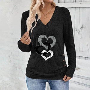 Detail of V-neck long sleeve top featuring triple heart print and decorative buttons