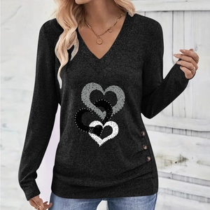 Detail of V-neck long sleeve top with triple heart print and side button decorations