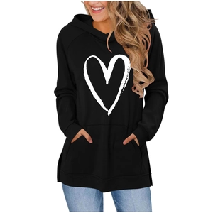 Close-up of black women's hoodie featuring white heart print and kangaroo pocket detail