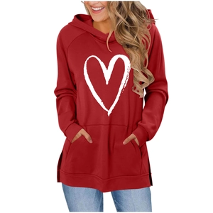 Detail of red women's hoodie featuring a white heart print and large front pocket