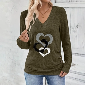 Detail of V-neck top with heart print, olive green fabric, and decorative side buttons