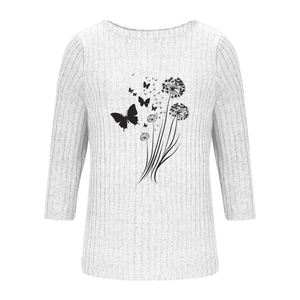 Detail of white ribbed knit fabric with dandelion and butterfly graphic print