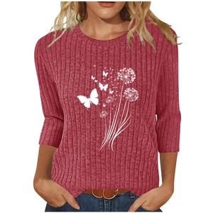 Detail of white butterfly and dandelion print on pink ribbed knit women's top