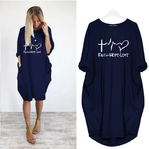 Detail of navy blue Faith Hope Love dress with long sleeves and side pockets