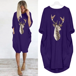 Détail d'une robe ample violet foncé avec imprimé tête de cerf doré et poches