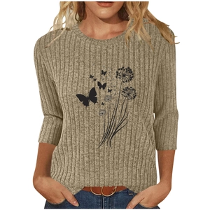 Detail of ribbed beige T-shirt featuring dandelion and butterfly print on soft knit fabric