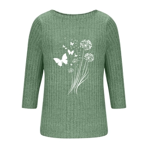 Close-up of grass green ribbed fabric with white dandelion and butterfly prints on top