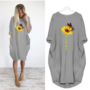 Detail of grey short sleeve dress featuring sunflower butterfly print and pocket