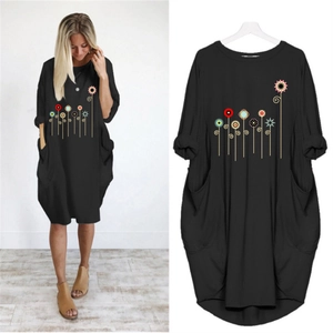 Women's black loose-fit crew neck dress featuring floral print and functional side pockets