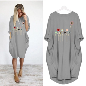 Detail of loose fit dark grey dress with abstract floral print and large side pockets