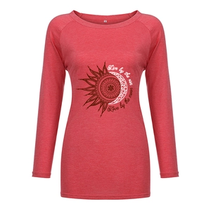 Close-up of bohemian sun and moon print on a long sleeve red cotton t-shirt
