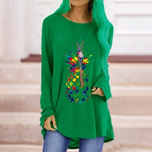 Women's green long sleeve t-shirt featuring a colorful artistic pineapple graphic print