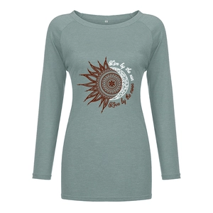 Detail of gray-green long sleeve tee showing the sun moon mandala and size label
