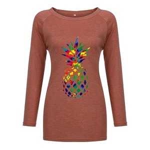 Close-up of heathered caramel fabric and colorful tie-dye pineapple print on long sleeve tee