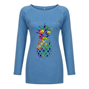 Close-up of the rainbow tie-dye pineapple print on a light blue long-sleeve T-shirt