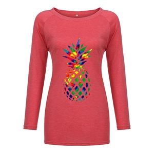 Detail of red crewneck long sleeve shirt featuring a vibrant watercolor pineapple print