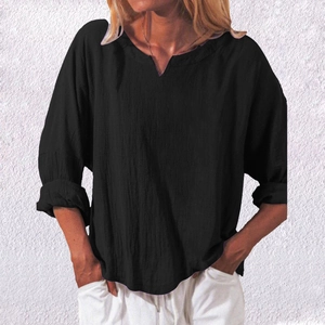 Detail of black cotton linen shirt with loose fit, V-neck design and textured fabric