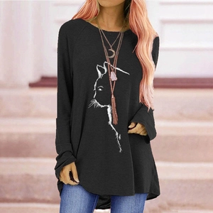 Detail of minimalist cat outline print on a loose black long-sleeved raglan t-shirt