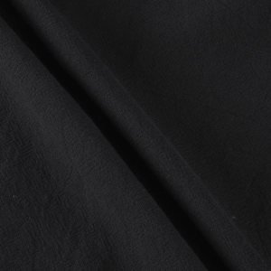 Macro shot of black linen-cotton fabric showing tight weave texture and soft drape detail