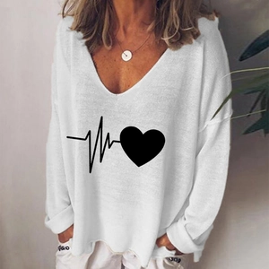 Close-up of heart and heartbeat print on a white V-neck oversized long sleeve shirt