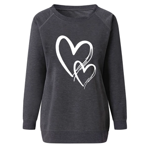 Detail of white heart print and ribbed knit texture on charcoal grey sweatshirt