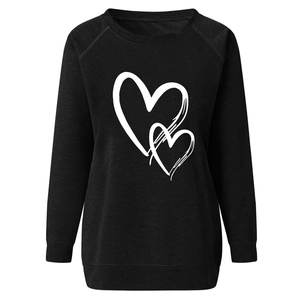 Detailed close-up of crewneck sweatshirt with minimalist double heart print in black
