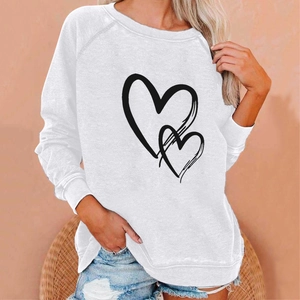 Detail of white crewneck sweatshirt featuring black twin heart print and ribbed cuffs