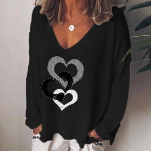 Detail of the V-neckline and triple woven heart prints on a black long sleeve tee