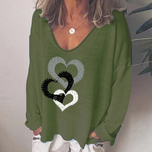 Detail view of heart print textures on women's olive green V-neck long sleeve T-shirt