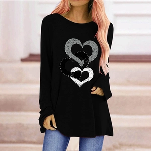 Close-up of three layered heart patterns on black long sleeve tee with textured prints
