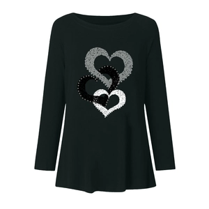 Detail of three overlapping textured hearts printed on a black long sleeve t-shirt