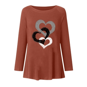 Detail of interlocking heart print on a rust red long sleeve t-shirt for women