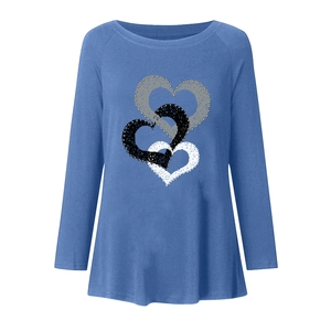 Detail of overlapping heart prints with silver bead embellishments on blue long sleeve tee