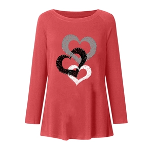 Detail of three overlapping heart prints on a long-sleeved crew neck t-shirt for women