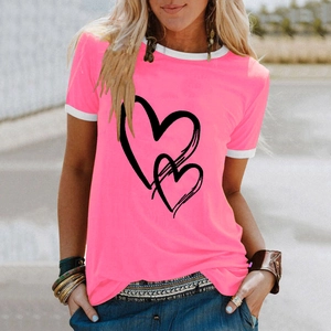 Detail of pink cotton T-shirt featuring black heart print and white contrast neck trim