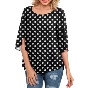 Detail of elegant black and white polka dot top with 3/4 split sleeves and scoop neck