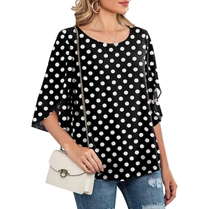Detail of elegant black and white polka dot chiffon blouse with stylish split sleeves