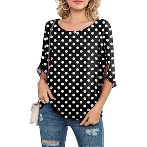 Detail of black polka dot top showing side-slit 3/4 sleeves and lightweight fabric texture