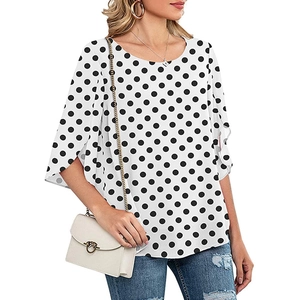 Close-up of elegant white 3/4 length sleeve with triple-layered ruffle detail on a dot blouse