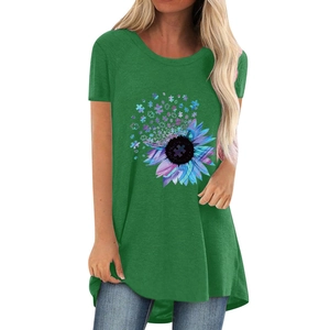 Close-up of women's forest green t-shirt featuring sunflower and puzzle piece graphic print