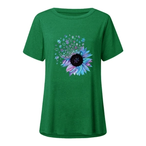 Detail of sunflower print with colorful jigsaw puzzle patterns on a green cotton T-shirt