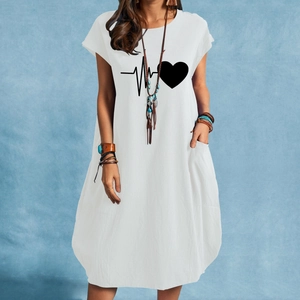 Detail shot of heartbeat and heart print on a white cotton linen summer dress with pockets