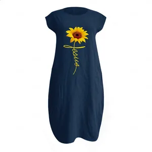 Detailed view of sunflower print and Jesus text on navy blue cotton linen dress texture