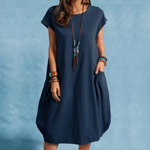 Detail of dark blue linen dress featuring side pockets and a bohemian aesthetic